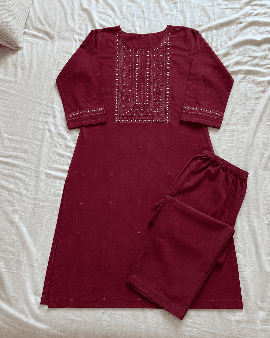 The same kurti, laid flat on a bed as originally photographed