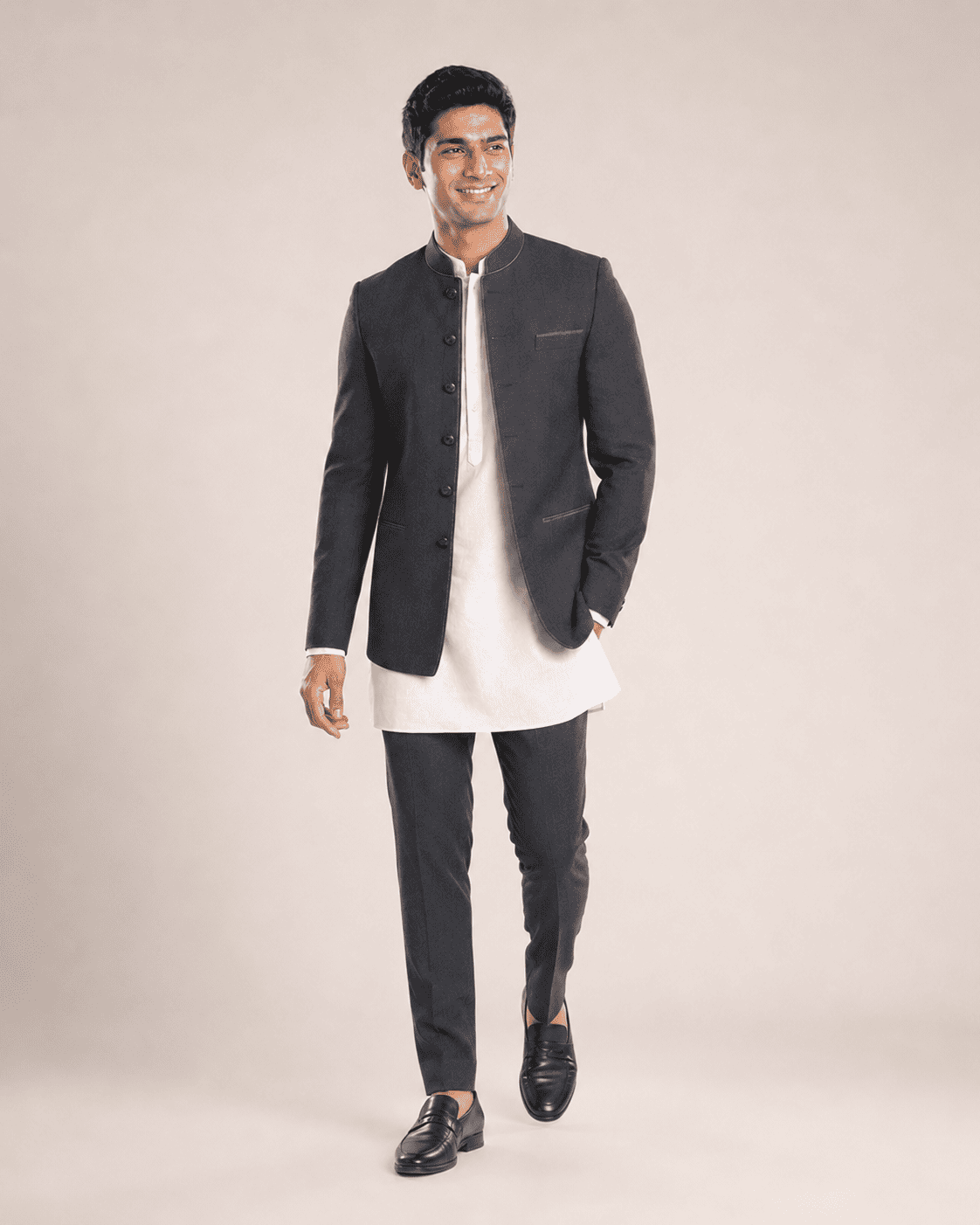 Arjun walking in a black bandhgala, lifestyle shot