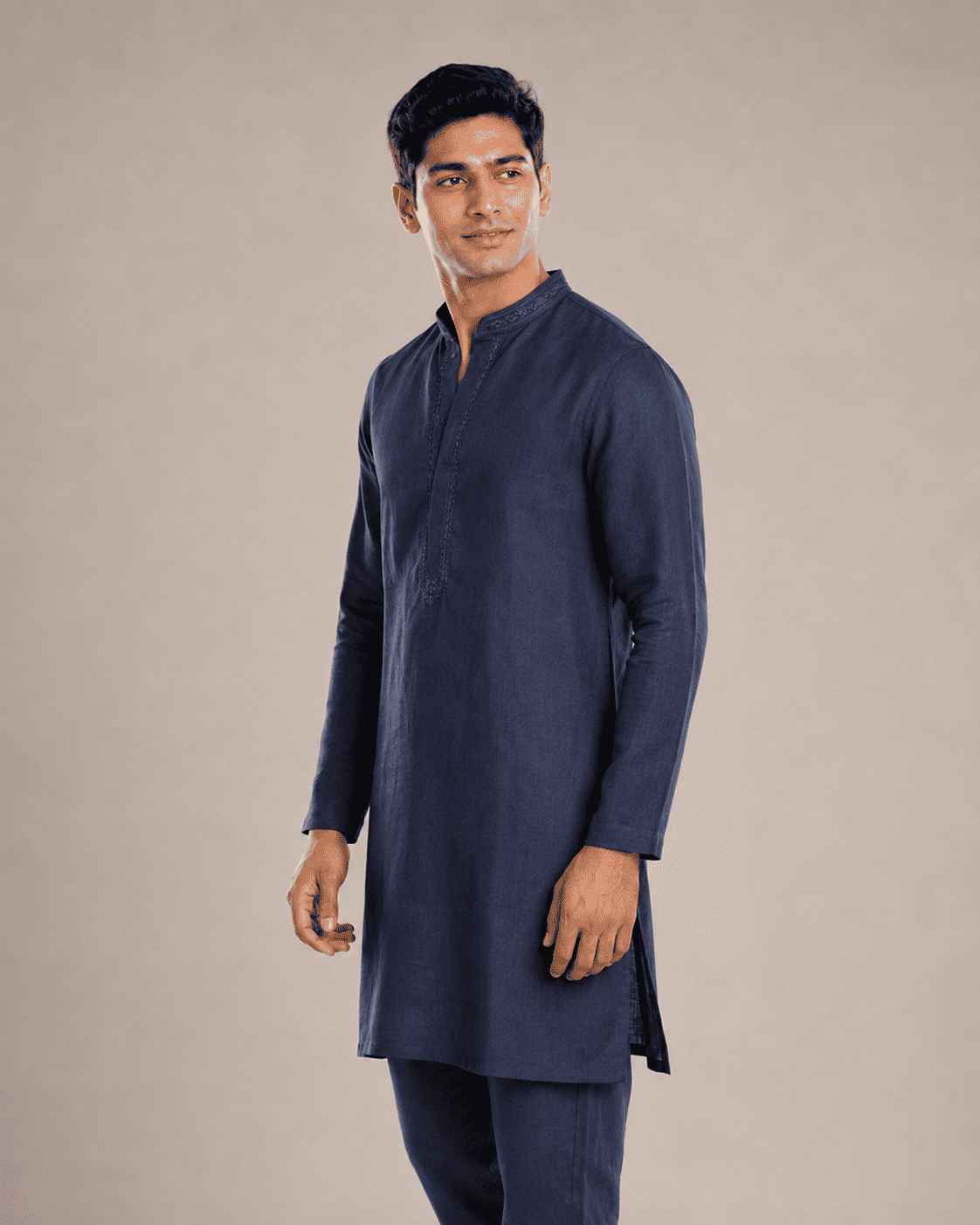 Arjun wearing a navy blue linen kurta, side view